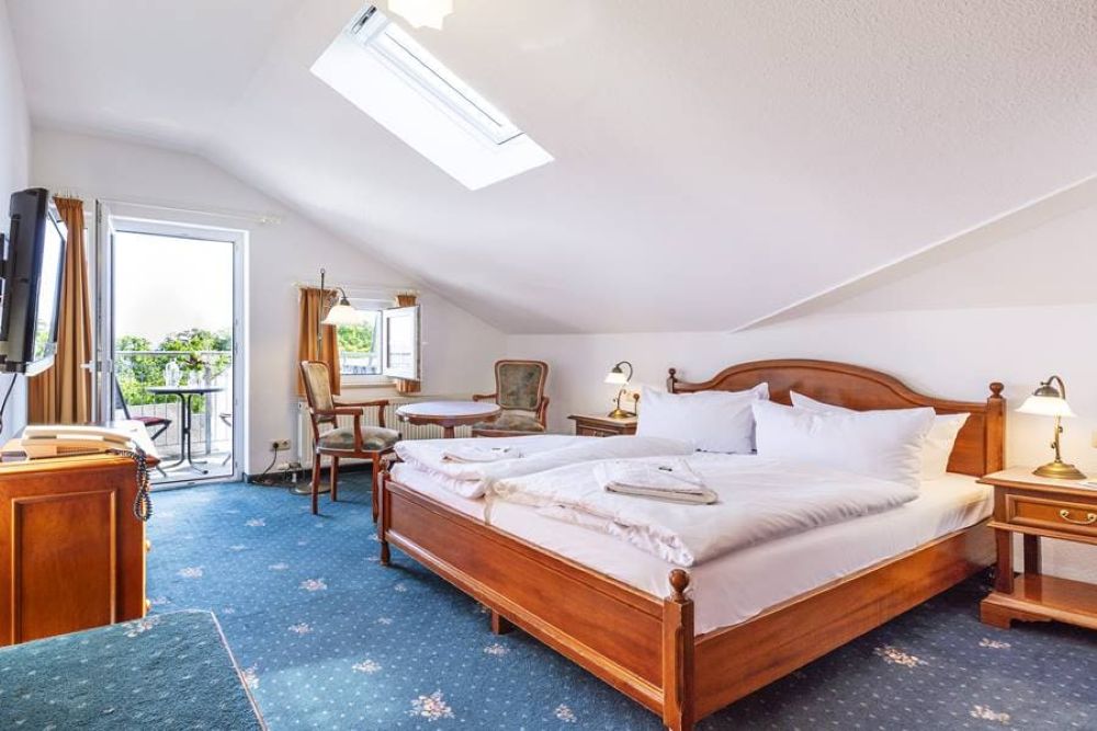 Book a double room with sloping ceilings at Hotel Stranddistel in Goehren, Ruegen Island